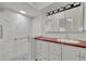 The updated bathroom has a tiled shower with a glass door and a modern vanity at 5614 King James Ave, Leesburg, FL 34748