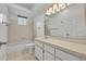 Clean bathroom with a single sink vanity, tile flooring, and a shower-tub combo at 5614 King James Ave, Leesburg, FL 34748
