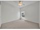Bedroom features natural light, a ceiling fan, and neutral carpet and color scheme at 5614 King James Ave, Leesburg, FL 34748