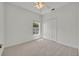 Comfortable bedroom with a ceiling fan, large window, and a closet at 5614 King James Ave, Leesburg, FL 34748