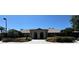 The front of the community clubhouse shows the covered entrance with manicured landscaping in a well-maintained community at 5614 King James Ave, Leesburg, FL 34748