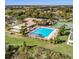 Aerial view of community pool, tennis courts, and clubhouse at 5614 King James Ave, Leesburg, FL 34748