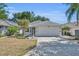 Charming single Gathering home with a well-manicured lawn and two car garage at 5614 King James Ave, Leesburg, FL 34748