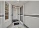 Entrance foyer featuring an exterior storm door and view to the living spaces at 5614 King James Ave, Leesburg, FL 34748