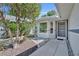 View of the front entry, walkway, and meticulously kept landscape and garden at 5614 King James Ave, Leesburg, FL 34748