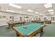 Spacious game room featuring multiple billiard tables, ceiling fans, and neutral wall paint at 5614 King James Ave, Leesburg, FL 34748