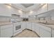 Classic kitchen with white appliances, tile floors and lots of counter space at 5614 King James Ave, Leesburg, FL 34748