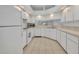 Bright kitchen with white cabinetry, tile floors, and modern appliances at 5614 King James Ave, Leesburg, FL 34748