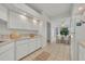 Bright kitchen features tile flooring, white cabinets, and a breakfast nook with a view of the yard at 5614 King James Ave, Leesburg, FL 34748