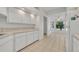 Bright kitchen features tile flooring, white cabinets, and plenty of counter space for meal preparation at 5614 King James Ave, Leesburg, FL 34748