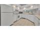 Updated kitchen featuring white cabinetry, modern appliances, and ample counter space at 5614 King James Ave, Leesburg, FL 34748