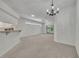 Bright open-concept living room with carpet floors, ceiling fan, and sliding glass doors at 5614 King James Ave, Leesburg, FL 34748
