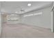 Open living space with neutral walls, carpeted floors, and lots of light at 5614 King James Ave, Leesburg, FL 34748