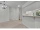 Open floor plan with neutral walls, updated fixtures and a bar seating area at 5614 King James Ave, Leesburg, FL 34748