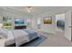 Spacious main bedroom featuring a ceiling fan, walk-in closet, and an ensuite bathroom at 5614 King James Ave, Leesburg, FL 34748