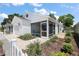 Charming home featuring a screened porch, attached garage, and nicely landscaped front yard at 5817 Valente Ct, The Villages, FL 32163