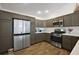 Modern kitchen featuring stainless steel appliances, ample cabinet space, and stylish countertops at 5817 Valente Ct, The Villages, FL 32163