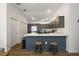 Kitchen featuring an eat-in island with two stools and stainless appliances at 5817 Valente Ct, The Villages, FL 32163