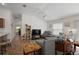 Spacious living room featuring wood-look floors, a ceiling fan, and a comfortable seating area at 5817 Valente Ct, The Villages, FL 32163