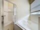 Bathroom with a glass-enclosed shower and soaking tub combo at 807 Wolf Creek St, Clermont, FL 34711
