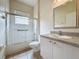 Bathroom featuring shower with glass door, single vanity, and tile flooring at 807 Wolf Creek St, Clermont, FL 34711