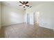Spacious bedroom featuring tile flooring, a ceiling fan, and multiple closets at 807 Wolf Creek St, Clermont, FL 34711