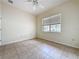 Bedroom with tile flooring, ceiling fan, neutral walls, and a window bringing in natural light at 807 Wolf Creek St, Clermont, FL 34711