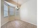 Bright dining area features tile floors, a bay window and decorative chandelier at 807 Wolf Creek St, Clermont, FL 34711