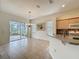 Dining area with chandelier and sliding glass doors to the lanai at 807 Wolf Creek St, Clermont, FL 34711