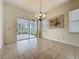 Dining space featuring a chandelier, large windows, and access to patio at 807 Wolf Creek St, Clermont, FL 34711