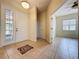 Bright foyer features tile flooring, a decorative rug, and a glass-paneled door allowing natural light at 807 Wolf Creek St, Clermont, FL 34711