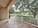 Charming front porch with brick flooring and white railing, offering serene neighborhood views and curb appeal at 807 Wolf Creek St, Clermont, FL 34711