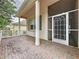 Welcoming front porch with brick flooring and screened entrance, offering a charming entryway to the home at 807 Wolf Creek St, Clermont, FL 34711