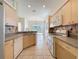 Open kitchen with gas range, microwave, and view of dining space at 807 Wolf Creek St, Clermont, FL 34711