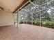 Spacious screened lanai with tile flooring, offering a tranquil outdoor space for enjoying nature and privacy at 807 Wolf Creek St, Clermont, FL 34711