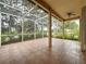Large screened lanai with tile flooring and a ceiling fan, ideal for enjoying outdoor living and serene views at 807 Wolf Creek St, Clermont, FL 34711