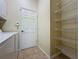 Well-equipped laundry room with washer, dryer, storage space, and tiled floor for easy maintenance at 807 Wolf Creek St, Clermont, FL 34711