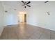 Bright living room featuring tile floors, ceiling fan, and neutral paint at 807 Wolf Creek St, Clermont, FL 34711