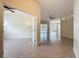Spacious living room with tile flooring throughout, ceiling fans, and access to outdoor living areas at 807 Wolf Creek St, Clermont, FL 34711