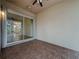 Covered patio with sliding glass door and views of the screened outdoor space and backyard at 807 Wolf Creek St, Clermont, FL 34711