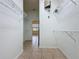 Spacious walk-in closet with tile flooring and wire shelving for organized storage, leading to another room at 807 Wolf Creek St, Clermont, FL 34711
