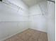 Walk-in closet with tile flooring and wire shelving for optimal storage solutions at 807 Wolf Creek St, Clermont, FL 34711