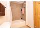 Compact bathroom featuring a tiled shower-tub combo and a white shower curtain for added privacy at 8091 C 476B, Bushnell, FL 33513