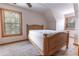 Bedroom featuring a wooden bed frame, neutral carpet and trim, and natural light from two windows at 8091 C 476B, Bushnell, FL 33513