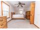 Bedroom featuring a wooden bed frame, matching dresser and cabinetry, neutral carpet and trim, and natural light at 8091 C 476B, Bushnell, FL 33513