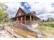 Charming two-story home with multiple porches, a ramp, and surrounded by lush greenery at 8091 C 476B, Bushnell, FL 33513