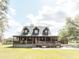 Inviting home with a wraparound porch, a beautiful lawn, and convenient ramp access at 8091 C 476B, Bushnell, FL 33513