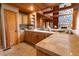 Well-equipped kitchen with wooden cabinets, tiled countertops, and a sink with a view at 8091 C 476B, Bushnell, FL 33513