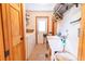 Laundry room with washer, sink, shelving, and a door, efficiently designed with light tile floors at 8091 C 476B, Bushnell, FL 33513