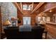 Cozy living room with a stone fireplace, wooden walls, and high vaulted ceilings with exposed beams at 8091 C 476B, Bushnell, FL 33513